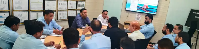 Our consultant leading an audit review with a client's management team around a boardroom table