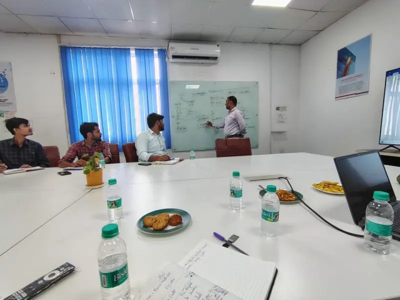 Our consultant explaining a process flow on a whiteboard during a client training session